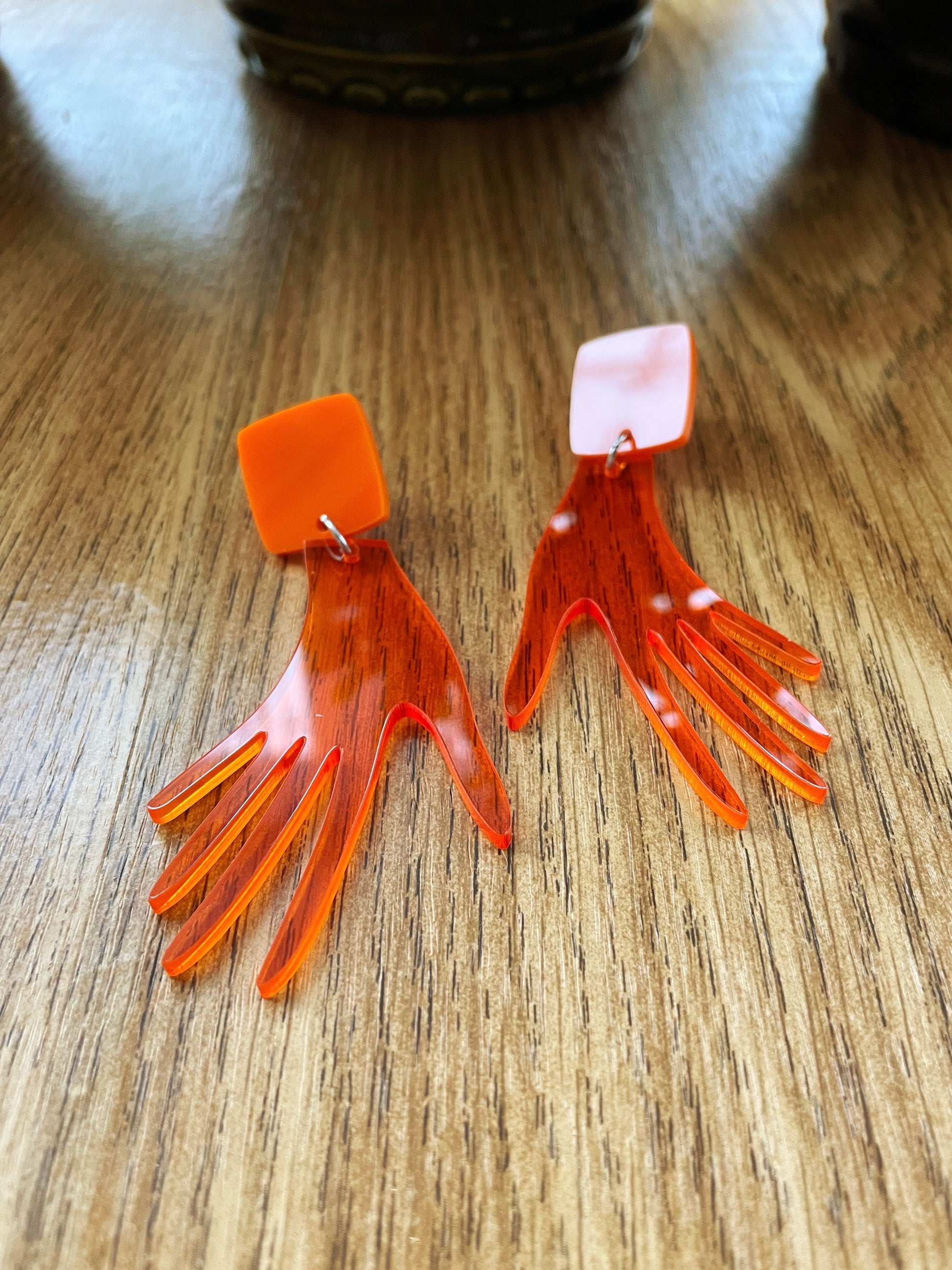 orange hand earrings